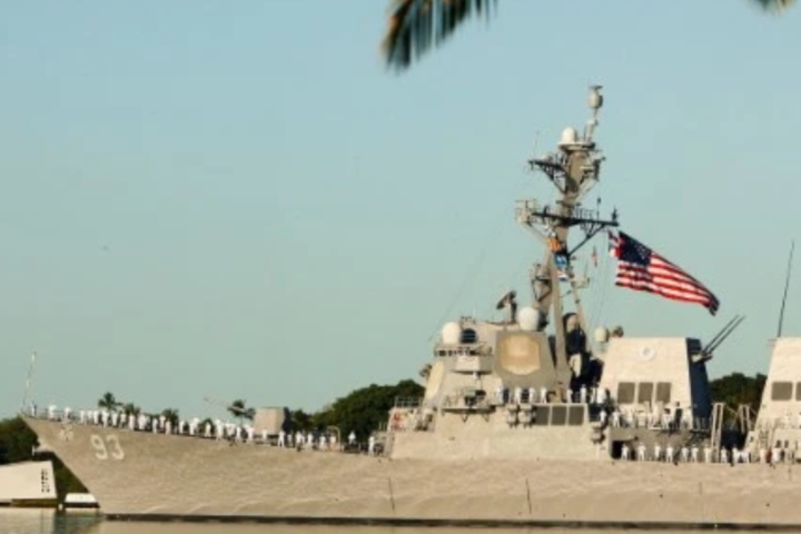 Two German warships are awaiting orders from Berlin to determine if they will be the first German naval vessel.